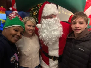 Smiling children receiving toys from Santa at a community toy drive